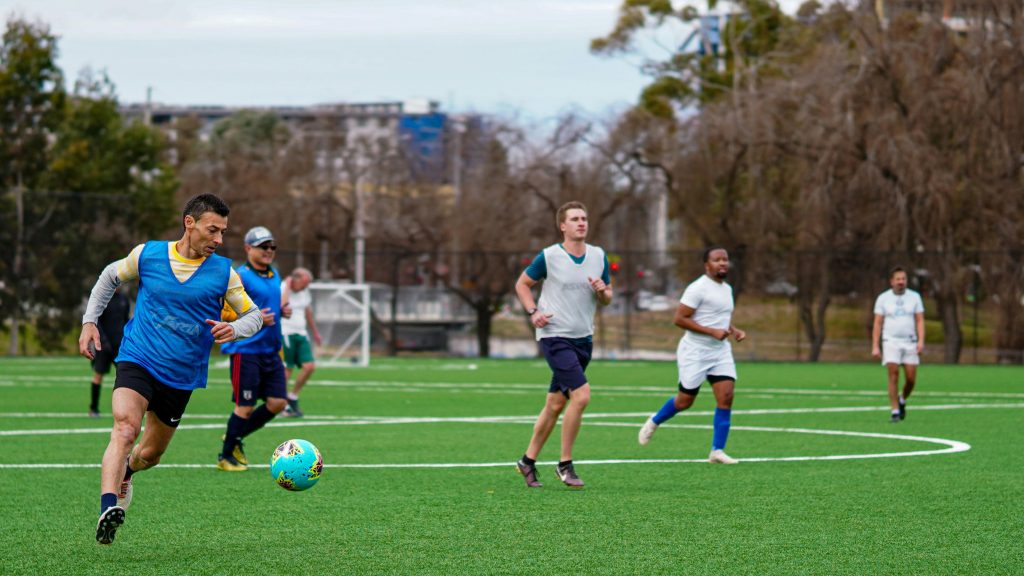 Adult man playing a game of pickup soccer